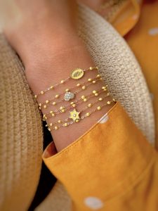 pulseras_gigiCLOZEAU_en_tonalidad_amarilla sobre_la_muñeca_de_una_modelo